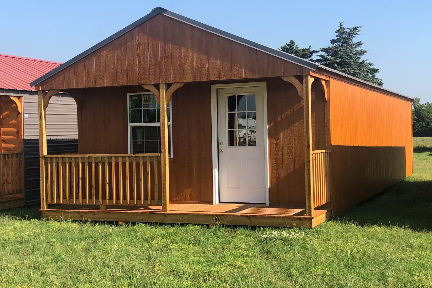 Wooden portable cabin with front porch and single white door