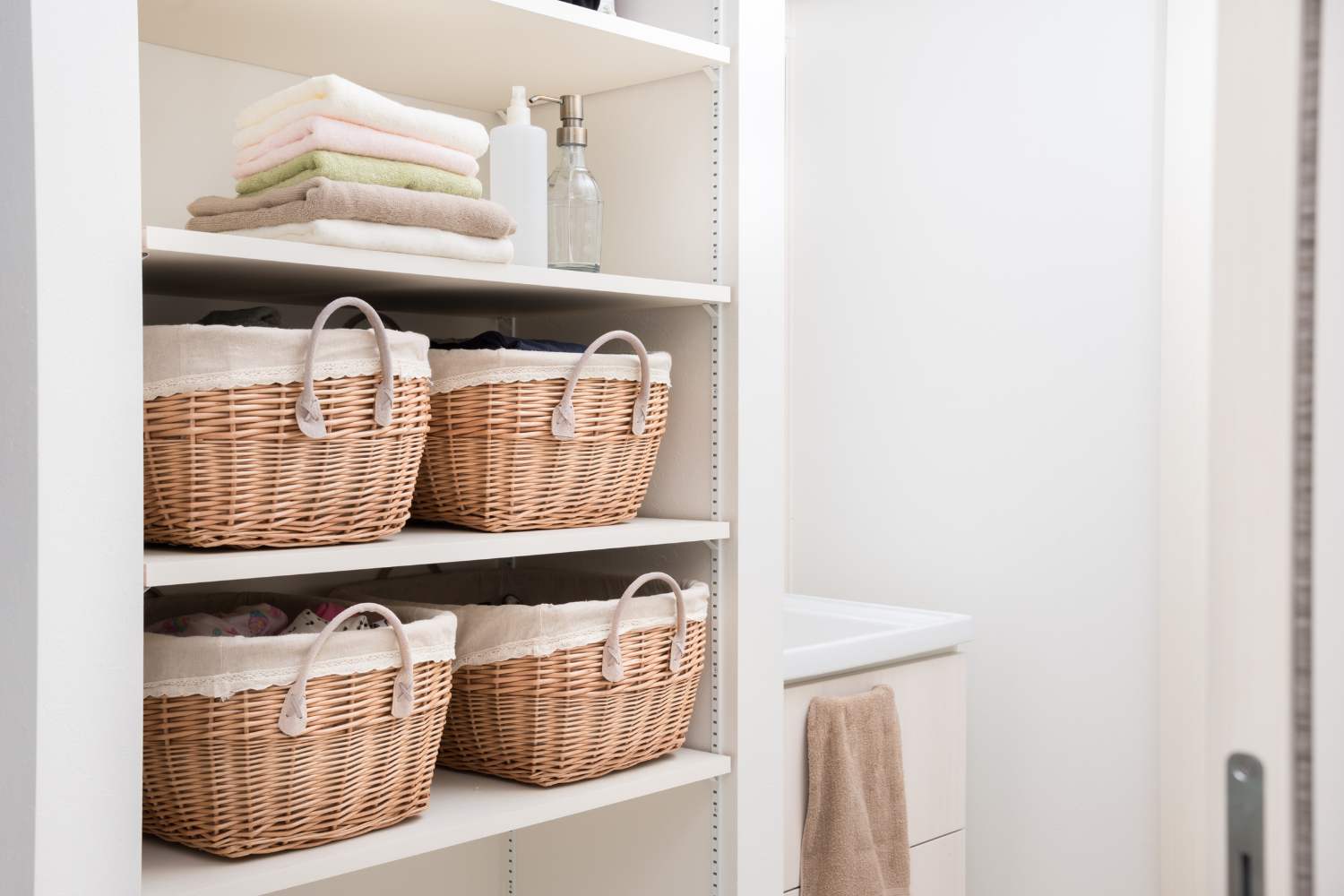 View of Bathroom storage space with baskets and towels